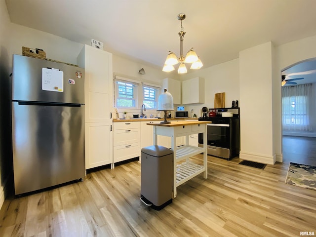 245 W Mcclernand Ave, Shawneetown, IL 62984 - kitchen with stainless steel appliances, wood counters, white cabinetry, and light wood-type flooring