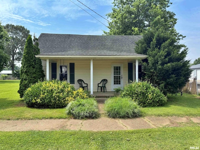 104 E 5th St, Brookport, IL 62910 - view of front of home with a porch, a front yard, and roof with shingles