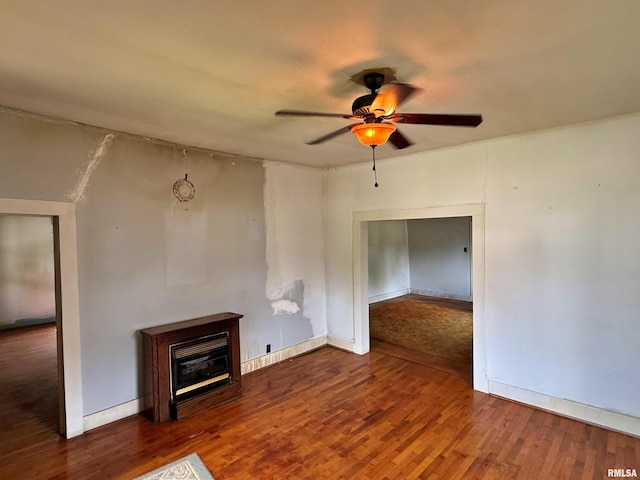 104 E 5th St, Brookport, IL 62910 - unfurnished living room featuring ceiling fan, wood finished floors, and a glass covered fireplace