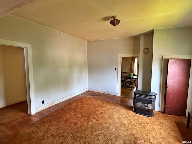 104 E 5th St, Brookport, IL 62910 - unfurnished room featuring a wood stove and wood finished floors