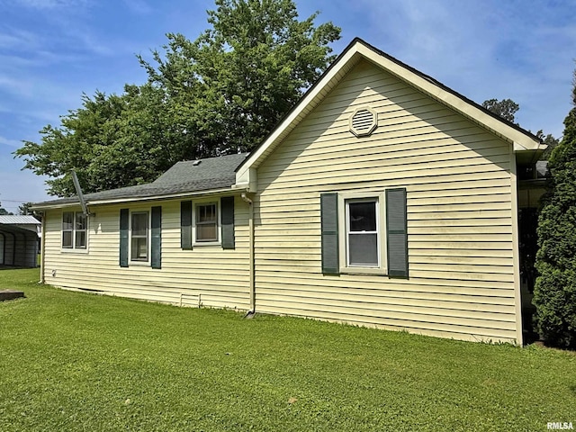 104 E 5th St, Brookport, IL 62910 - view of property exterior featuring a yard and a detached carport