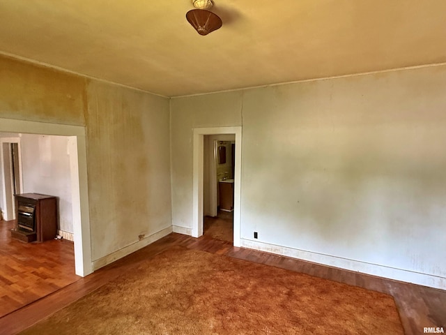 104 E 5th St, Brookport, IL 62910 - empty room featuring wood finished floors and a wood stove