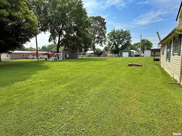 104 E 5th St, Brookport, IL 62910 - view of green lawn with a garage and a shed