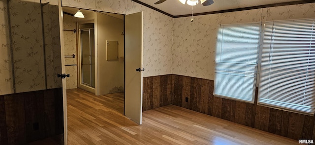 45 Donetta Ln, Creal Springs, IL 62922 - empty room with wallpapered walls, light wood-style flooring, a ceiling fan, wainscoting, and crown molding