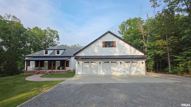 2940 Parrish Rdg, Goreville, IL 62939 - view of front facade with covered porch, a front yard, gravel driveway, an attached garage, and a metal roof
