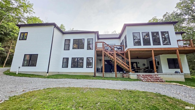 2940 Parrish Rdg, Goreville, IL 62939 - rear view of house featuring a wooden deck, stairway, a lawn, and driveway