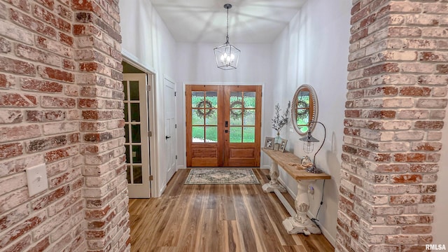2940 Parrish Rdg, Goreville, IL 62939 - foyer entrance with hardwood / wood-style floors, brick wall, a chandelier, and french doors