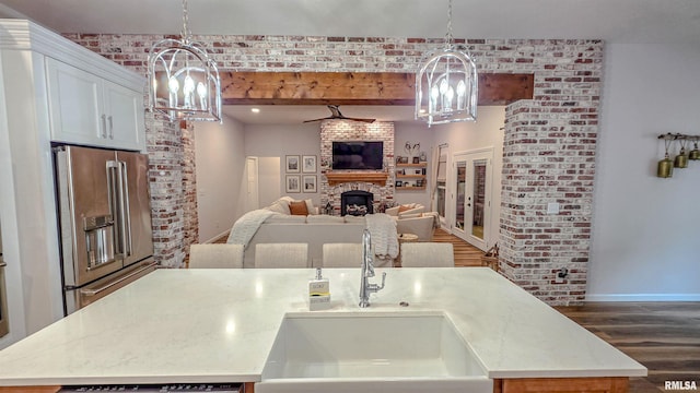 2940 Parrish Rdg, Goreville, IL 62939 - kitchen with a chandelier, high end fridge, dark wood finished floors, a center island with sink, and beam ceiling