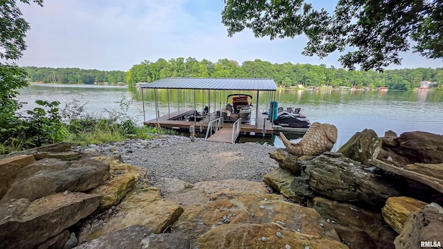2940 Parrish Rdg, Goreville, IL 62939 - dock featuring boat lift, a view of trees, and a water view