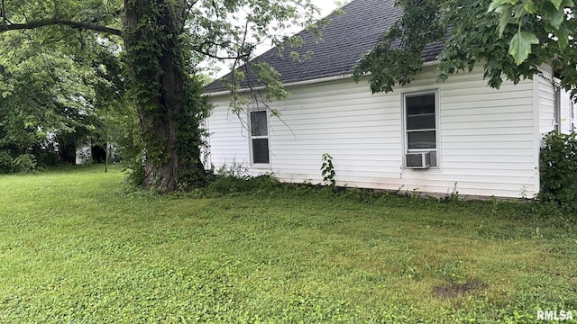 404 E Main St, Buckner, IL 62812 - view of side of property featuring a yard, a shingled roof, and cooling unit