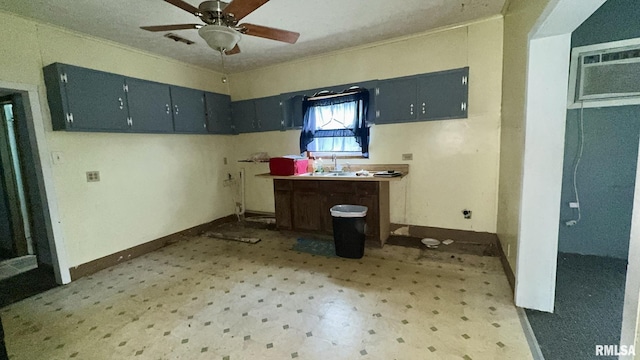 404 E Main St, Buckner, IL 62812 - kitchen featuring light floors, ceiling fan, a wall mounted air conditioner, and crown molding
