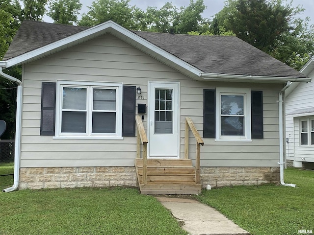 211 Charles St, Benton, IL 62812 - bungalow with entry steps, roof with shingles, and a front lawn