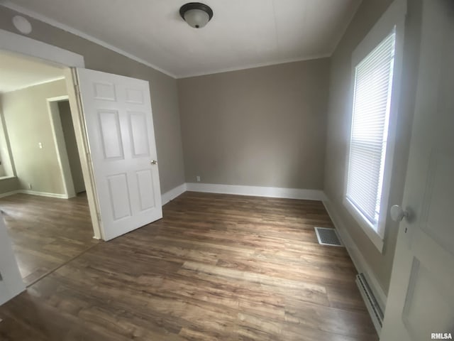 211 Charles St, Benton, IL 62812 - spare room featuring baseboard heating, ornamental molding, and wood finished floors