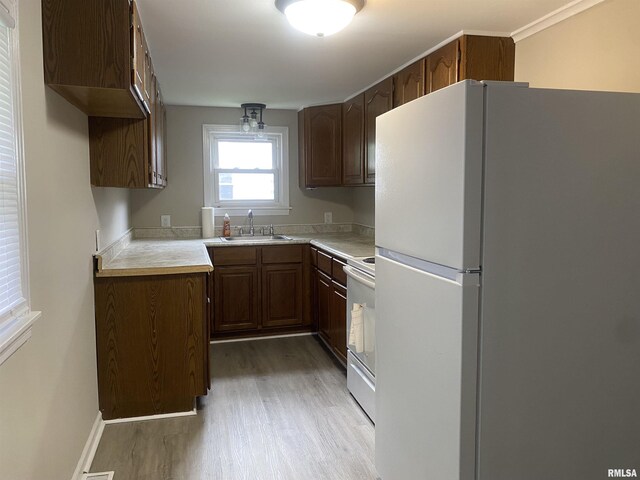 211 Charles St, Benton, IL 62812 - kitchen featuring white appliances, light wood-style floors, and light countertops