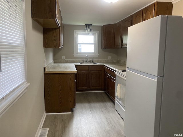 211 Charles St, Benton, IL 62812 - kitchen featuring white appliances, light wood finished floors, and light countertops