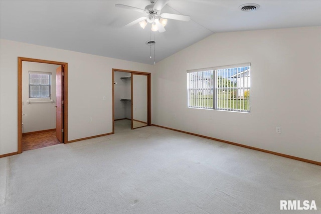 1504 Apache Dr, Marion, IL 62959 - unfurnished bedroom featuring light colored carpet, multiple windows, vaulted ceiling, ensuite bathroom, and a closet