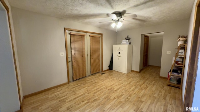2209 Cedar Hill Rd, West Frankfort, IL 62896 - unfurnished bedroom with light wood finished floors, a closet, a textured ceiling, and a ceiling fan