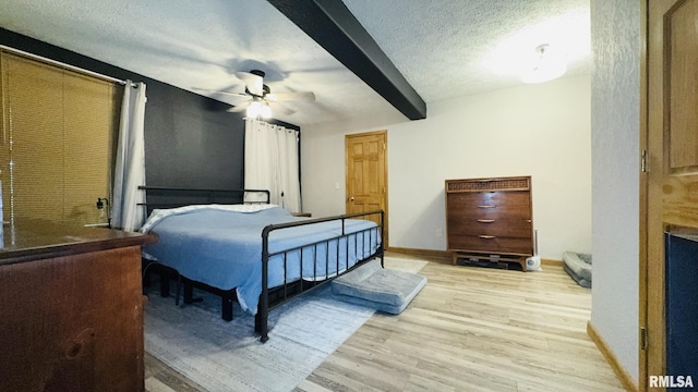 2209 Cedar Hill Rd, West Frankfort, IL 62896 - bedroom with light wood-type flooring, beam ceiling, a textured ceiling, and a ceiling fan