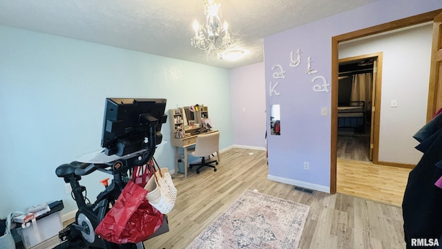 2209 Cedar Hill Rd, West Frankfort, IL 62896 - game room with wood finished floors, a chandelier, a desk, and a textured ceiling