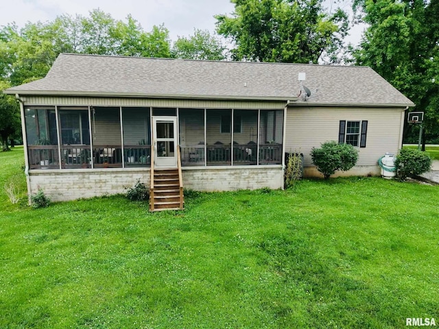 2209 Cedar Hill Rd, West Frankfort, IL 62896 - back of property featuring a sunroom, roof with shingles, and a yard