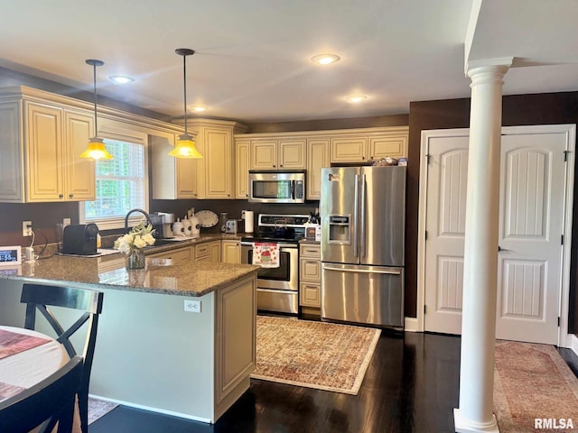 5024 Rosebud Rd, Metropolis, IL 62960 - kitchen featuring stainless steel appliances, decorative columns, a peninsula, stone countertops, and hanging light fixtures