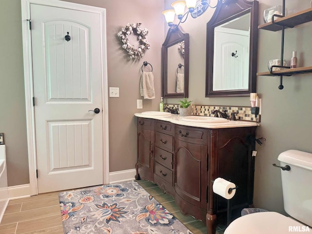 5024 Rosebud Rd, Metropolis, IL 62960 - full bathroom with double vanity, wood finished floors, and tasteful backsplash