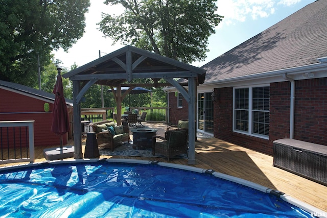 5024 Rosebud Rd, Metropolis, IL 62960 - view of swimming pool with a gazebo, a wooden deck, a covered pool, and an outdoor living space with a fire pit