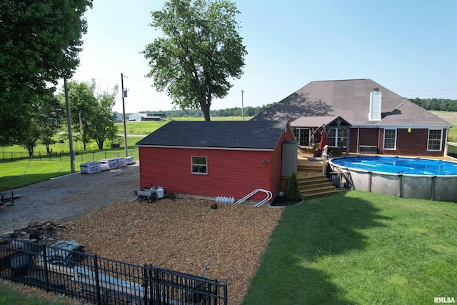 5024 Rosebud Rd, Metropolis, IL 62960 - rear view of property with a wooden deck, an outdoor pool, and a shingled roof