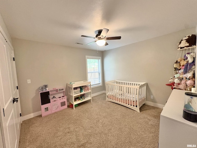 408 Madison St, Cambria, IL 62915 - bedroom with carpet floors, a crib, and ceiling fan