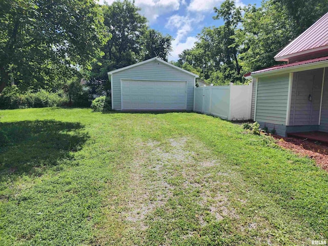 111 Bevard St, Carterville, IL 62918 - view of yard with a detached garage, an outbuilding, and view of wooded area