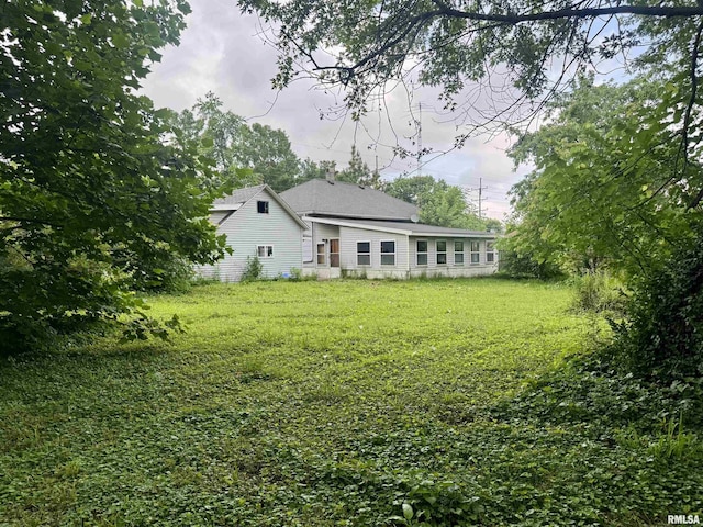 809 Highland St, Benton, IL 62812 - rear view of property featuring a lawn and a shingled roof