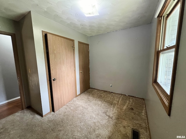 20 Suburban Dr, Murphysboro, IL 62966 - unfurnished bedroom featuring carpet flooring and multiple closets