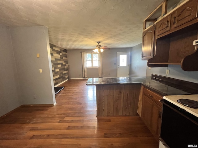20 Suburban Dr, Murphysboro, IL 62966 - kitchen featuring black range with electric cooktop, a peninsula, a textured ceiling, dark wood finished floors, and ceiling fan