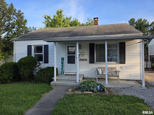 2805 College St, Mount Vernon, IL 62864 - view of front of home featuring a chimney, a front yard, and a shingled roof