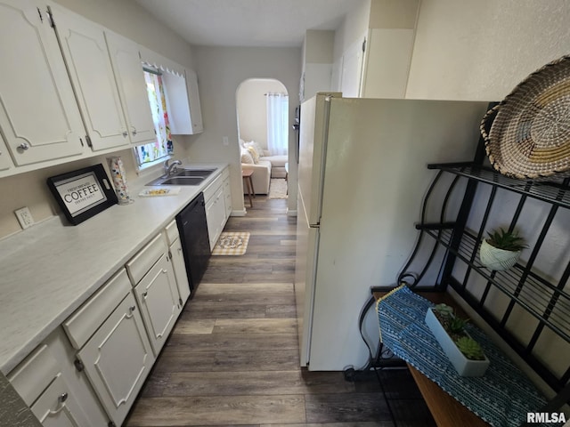 2805 College St, Mount Vernon, IL 62864 - kitchen with dark wood-style floors, white cabinets, light countertops, arched walkways, and dishwasher