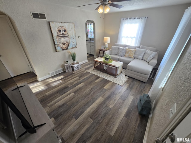 2805 College St, Mount Vernon, IL 62864 - living area featuring arched walkways, a textured wall, ceiling fan, wood finished floors, and a textured ceiling