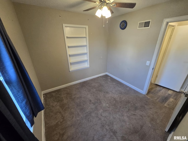 2805 College St, Mount Vernon, IL 62864 - spare room featuring carpet floors, built in features, ceiling fan, and a textured ceiling