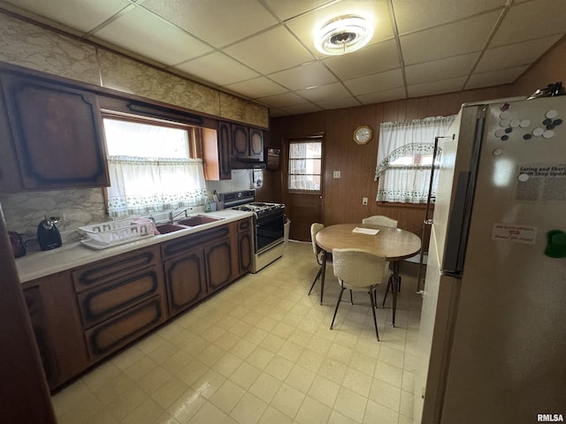 306 W Kaskaskia St, Pinckneyville, IL 62274 - kitchen with white appliances, light floors, light countertops, a paneled ceiling, and under cabinet range hood