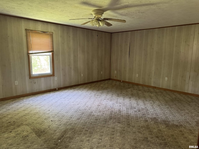 9004 Old State Route 14th Rte, Duquoin, IL 62832 - spare room with ceiling fan, a textured ceiling, carpet floors, and wooden walls