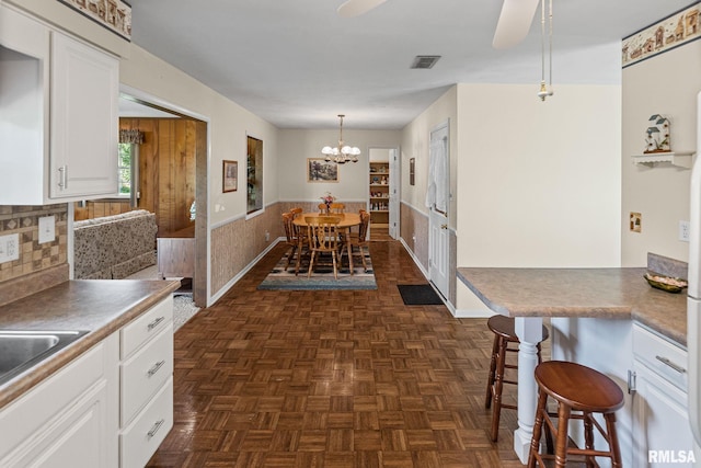 10 Monroe Ave, Salem, IL 62881 - dining space with a wainscoted wall, a chandelier, and ceiling fan