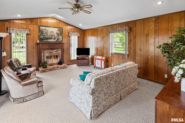 10 Monroe Ave, Salem, IL 62881 - carpeted living area featuring a ceiling fan, lofted ceiling, a brick fireplace, and wooden walls