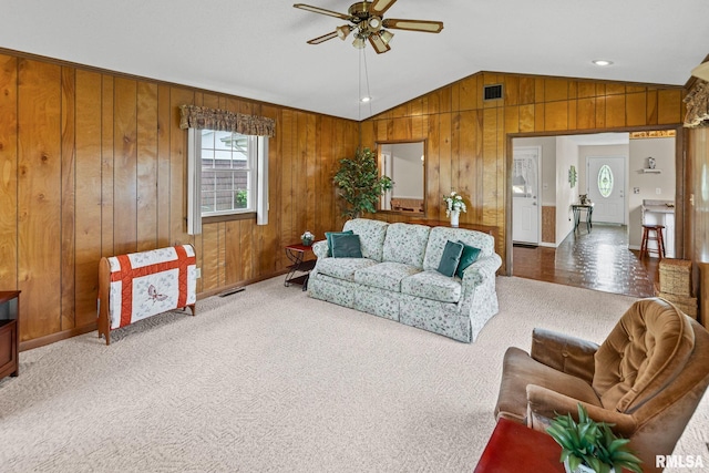 10 Monroe Ave, Salem, IL 62881 - living area featuring a ceiling fan, lofted ceiling, wooden walls, and carpet floors