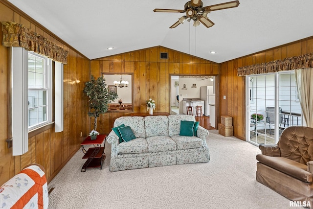 10 Monroe Ave, Salem, IL 62881 - living room featuring vaulted ceiling, wood walls, a ceiling fan, carpet floors, and a chandelier