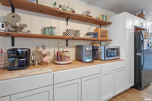 809 Dogwood Ln, Marion, IL 62959 - kitchen with open shelves, freestanding refrigerator, light wood-style flooring, white cabinetry, and crown molding