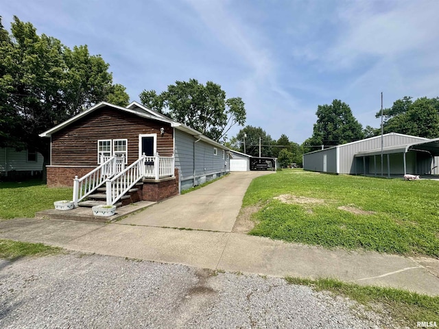 606 N Orchard St, West Frankfort, IL 62896 - view of side of home featuring a lawn, a garage, and an outdoor structure