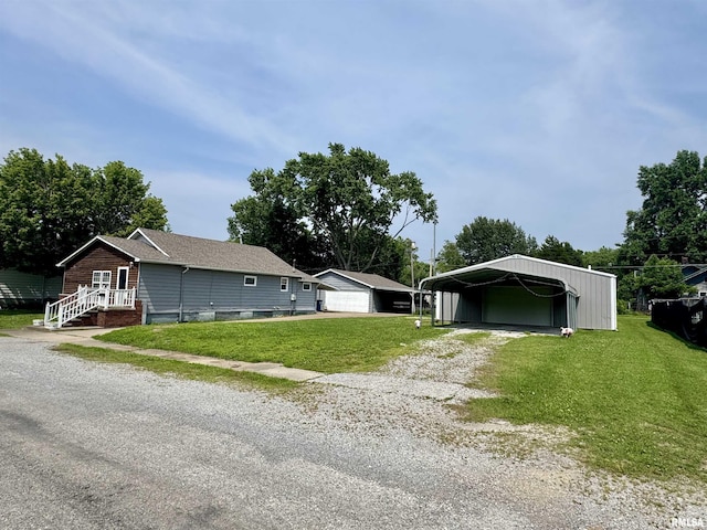 606 N Orchard St, West Frankfort, IL 62896 - view of front facade with an outbuilding, a front lawn, driveway, and a detached carport