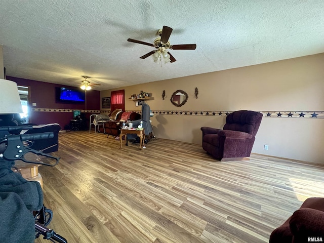 606 N Orchard St, West Frankfort, IL 62896 - living room featuring a textured ceiling, a ceiling fan, and wood finished floors