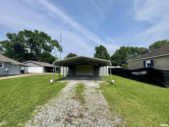 606 N Orchard St, West Frankfort, IL 62896 - view of front of property featuring a front yard, a carport, board and batten siding, and a garage