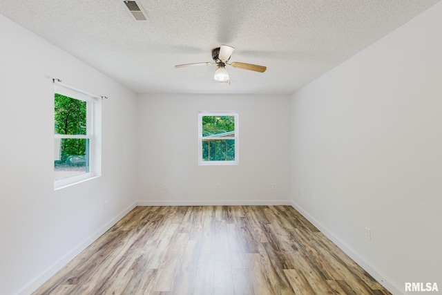 880 State Route 166, Creal Springs, IL 62922 - spare room with plenty of natural light, wood finished floors, ceiling fan, and a textured ceiling