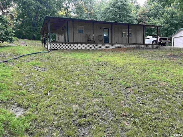 880 State Route 166, Creal Springs, IL 62922 - back of house with a lawn, a porch, a garage, and an outbuilding